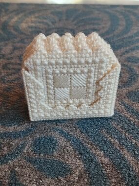 Handmade cream-colored plastic canvas coasters